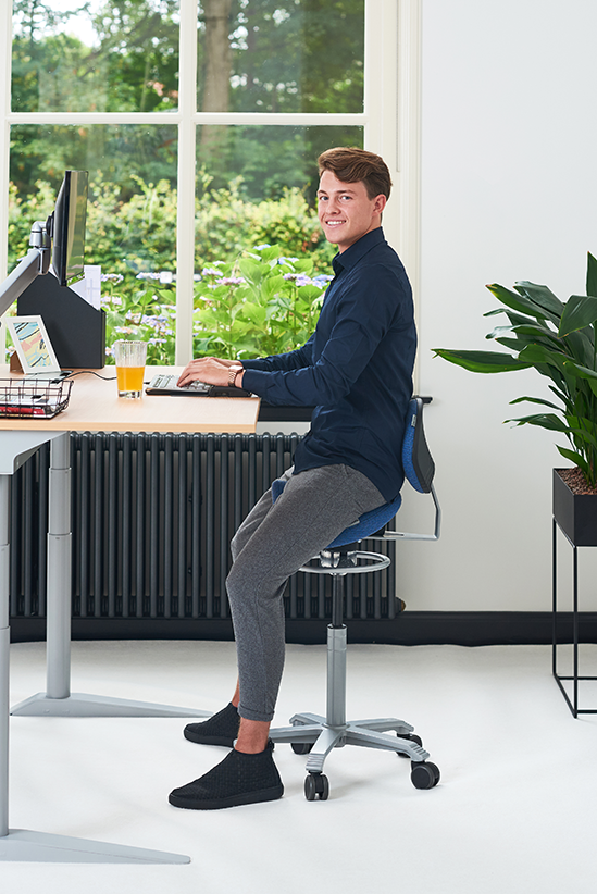 Healthy Sitting With Model On Saddle Chair With Lumbar Support